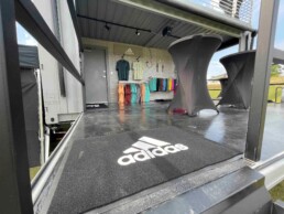 Retail space and showroom in ROXBOX Containers' custom Adidas Golf PGA Tour shipping container mobile experiential marketing activation.