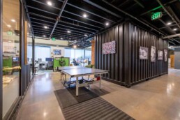 Game room and kitchen in Eldorado Climbing Walls shipping container office space built by ROXBOX Containers.