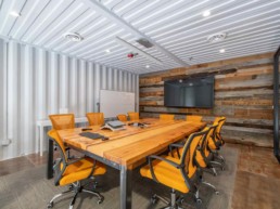 View of the conference room in Eldorado Climbing Walls shipping container office space built by ROXBOX Containers.