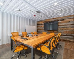 View of the conference room in Eldorado Climbing Walls shipping container office space built by ROXBOX Containers.