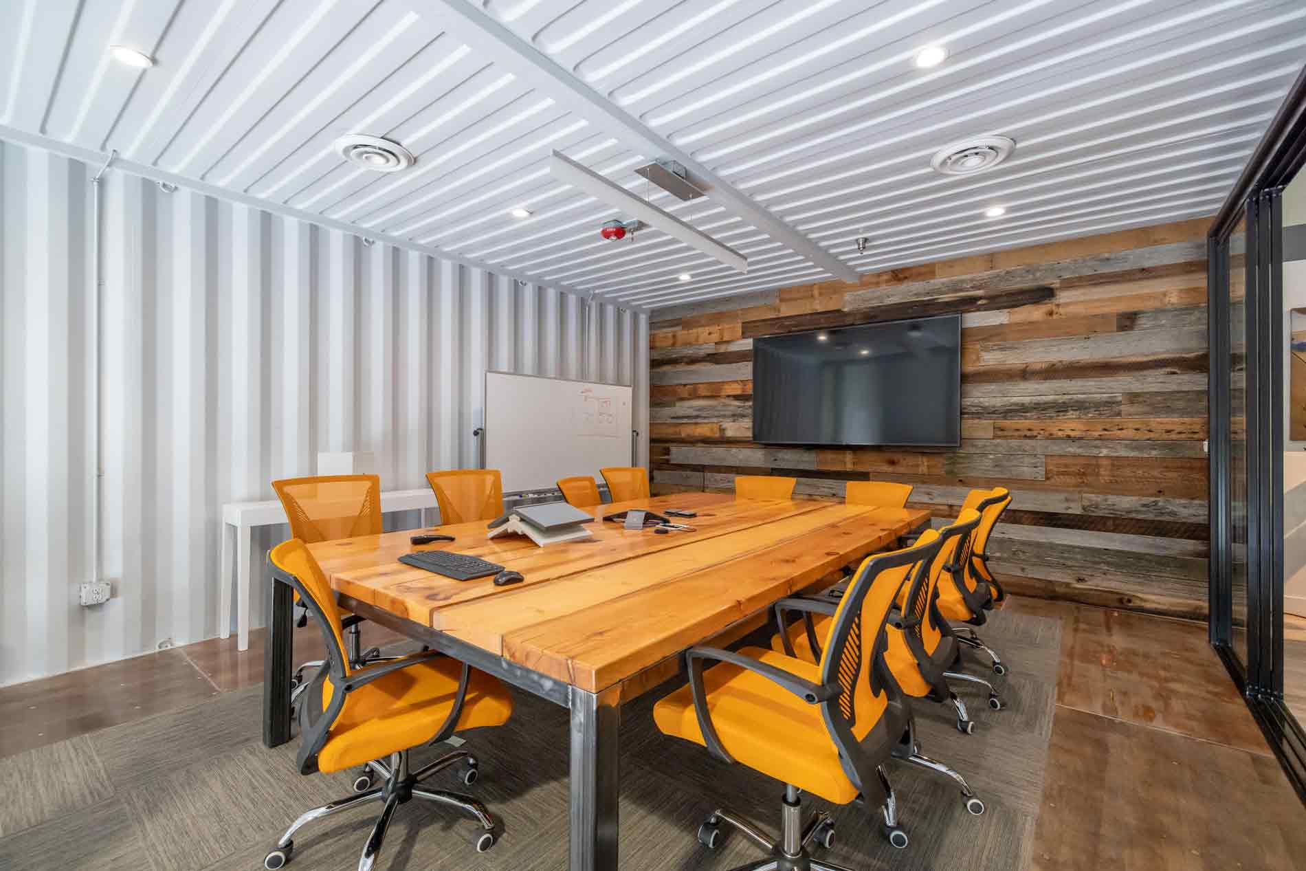 View of the conference room in Eldorado Climbing Walls shipping container office space built by ROXBOX Containers.