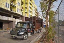 Price Development Group's custom shipping container patio bar built by ROXBOX Containers being delivered into location.