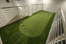 Putting green on the rooftop deck of ROXBOX Containers' custom Adidas Golf PGA Tour shipping container mobile experiential marketing activation.
